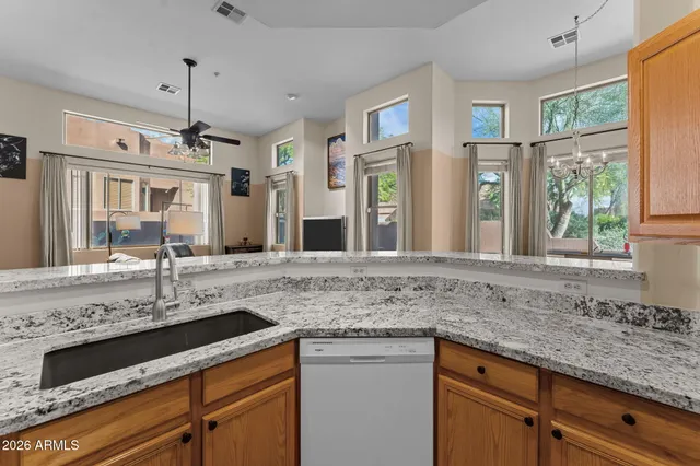 a bathroom with a double vanity sink mirror and lamp
