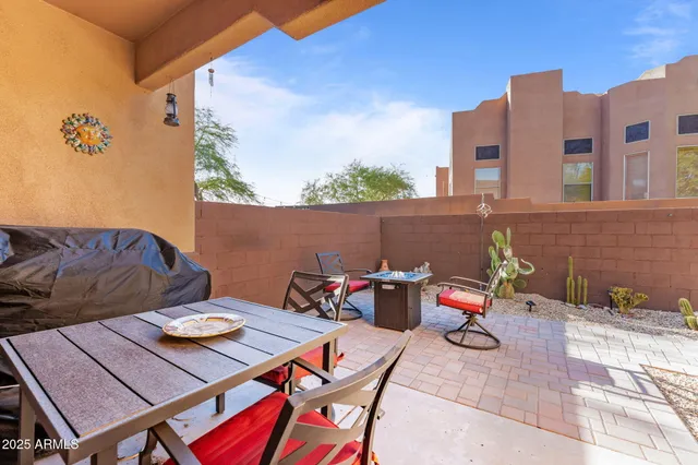 a view of a patio with table and chairs a barbeque
