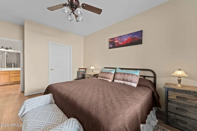 a bathroom with a granite countertop sink a toilet and a mirror