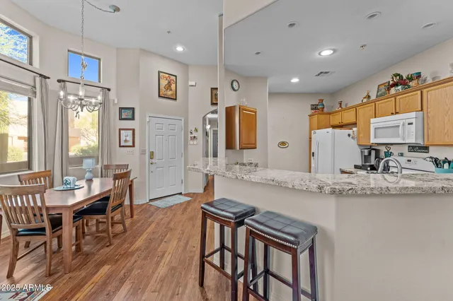 a large kitchen with a table and chairs