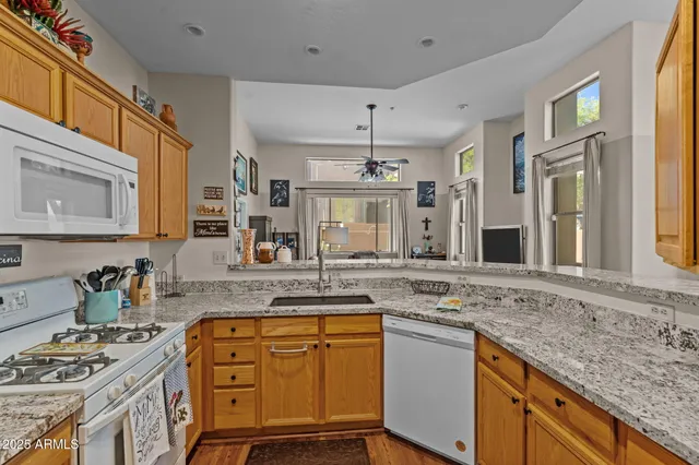 a kitchen with stainless steel appliances granite countertop a stove and a sink