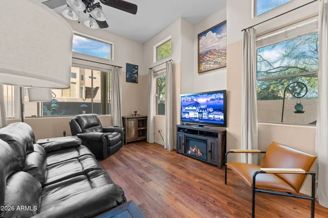 a living room with furniture a ceiling fan and a window