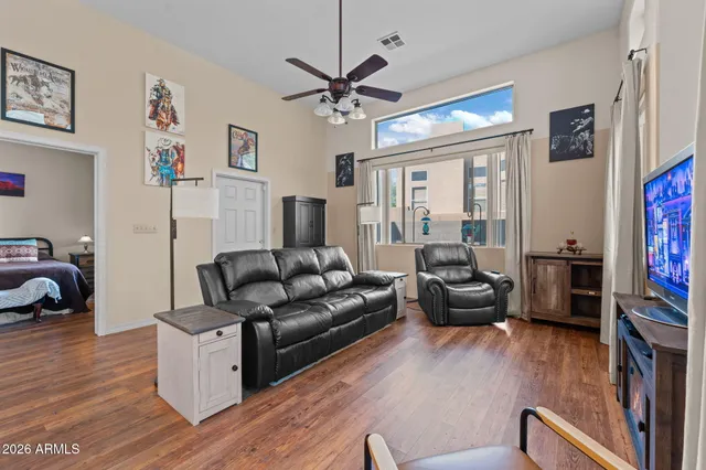 a living room with furniture a fireplace and a window