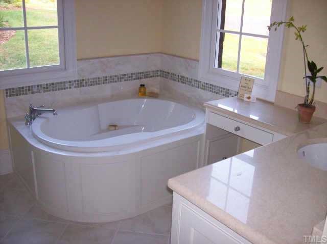 5331 Landguard Drive Raleigh, NC 27613 - Photo 8 of 10 a bath tub sitting in a bathroom next to a window