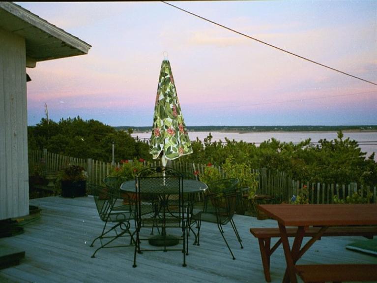 805 Chequessett Neck Road Wellfleet, MA 02667 - Photo 12 of 31 a view of a chairs and table on the wooden floor