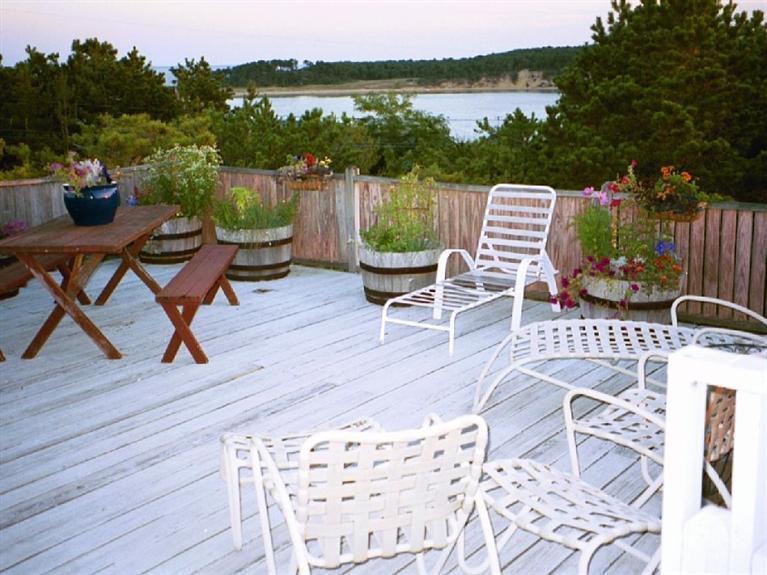 805 Chequessett Neck Road Wellfleet, MA 02667 - Photo 13 of 31 a view of a patio with chairs and a table
