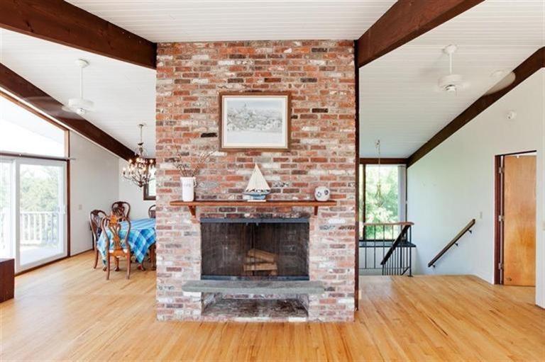 805 Chequessett Neck Road Wellfleet, MA 02667 - Photo 14 of 31 a view of a livingroom with furniture a fireplace and wooden floor