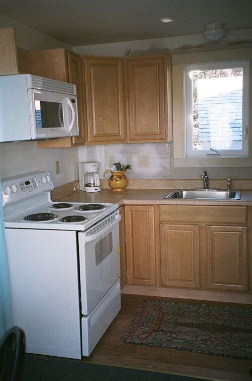 805 Chequessett Neck Road Wellfleet, MA 02667 - Photo 23 of 31 a kitchen with sink a microwave and cabinets