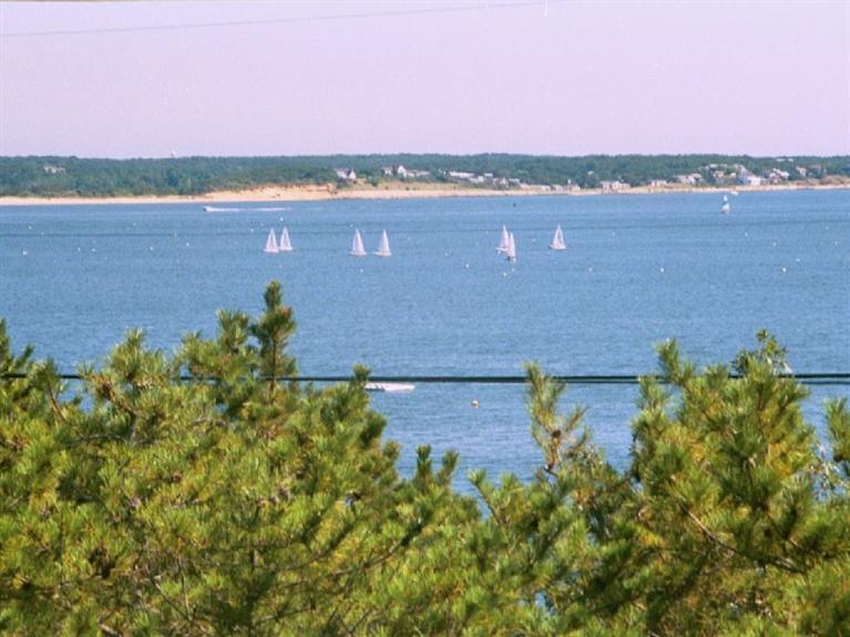 805 Chequessett Neck Road Wellfleet, MA 02667 - Photo 30 of 31 a view of a lake with a mountain in the background