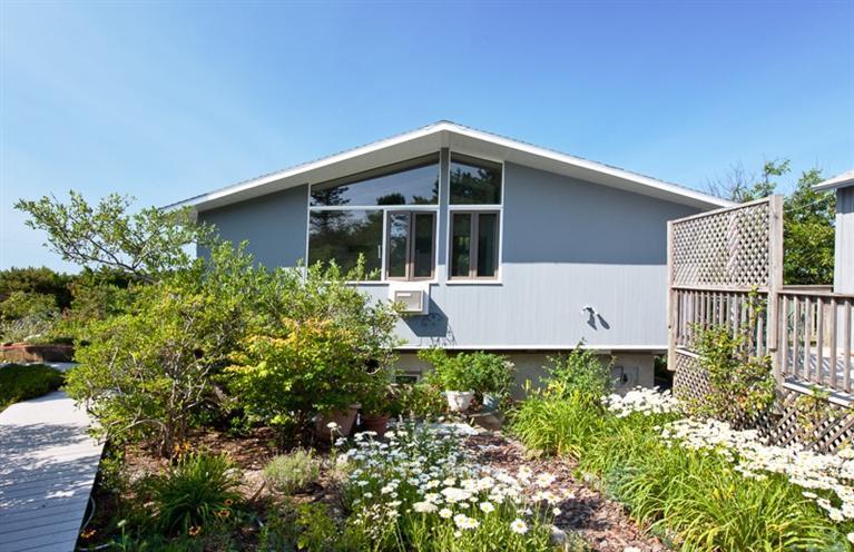 805 Chequessett Neck Road Wellfleet, MA 02667 - Photo 7 of 31 a front view of a house with a yard
