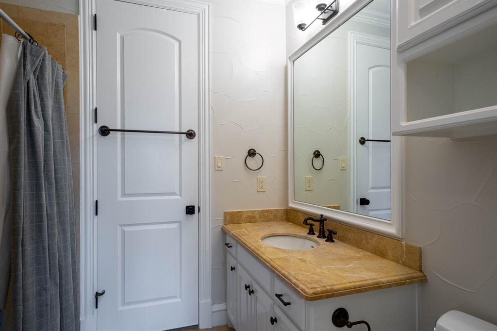 2101 Vail Road Southlake, TX 76092 - Photo 30 of 40 a bathroom with a granite countertop sink and a mirror
