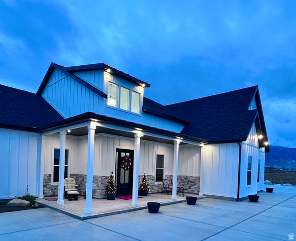 1952 Highway 118 Monroe, UT 84754 - Photo 1 of 88 View of front of house featuring board and batten siding, a porch, a shingled roof, and stone siding