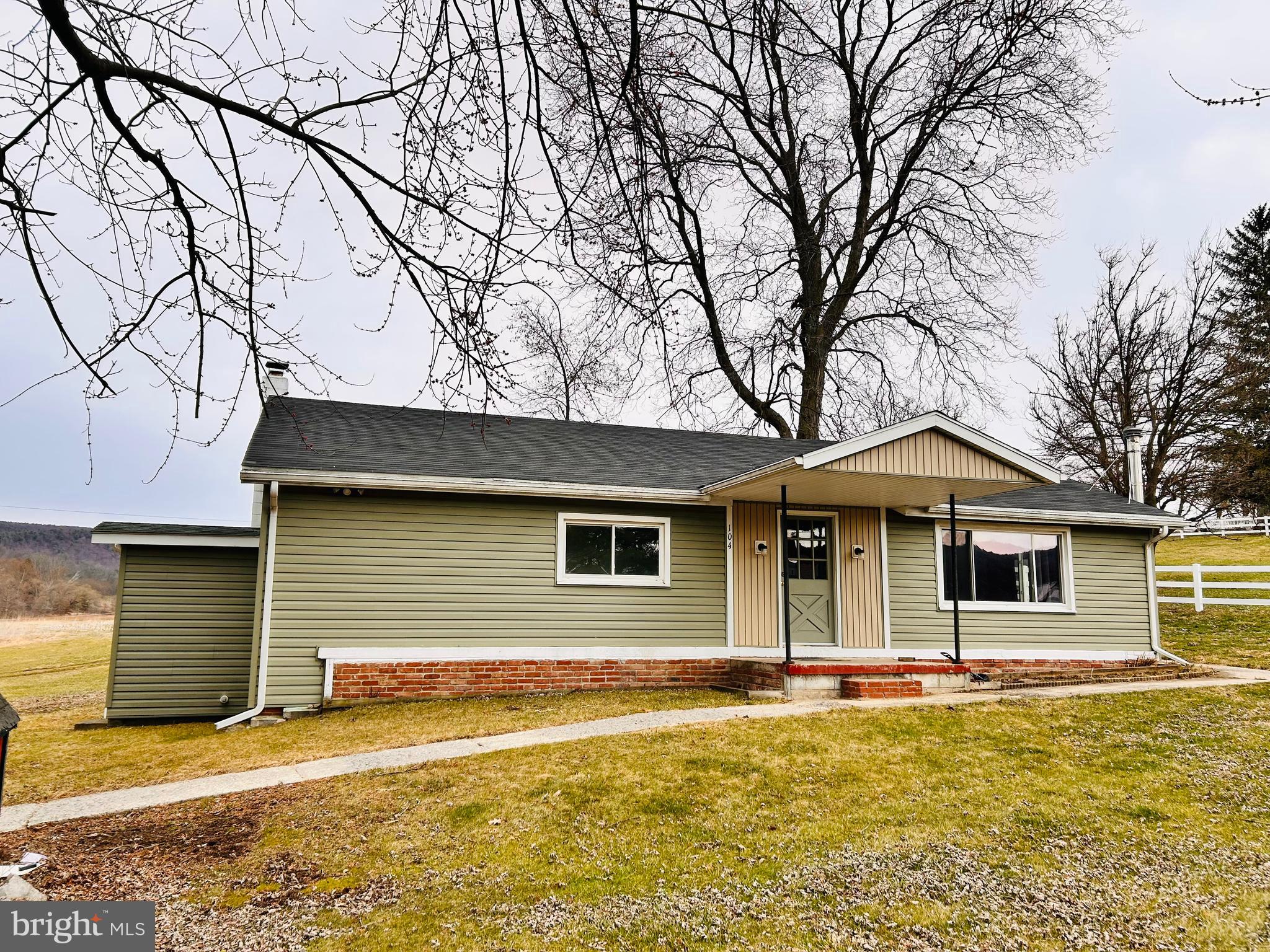 a house that has a tree in front of it