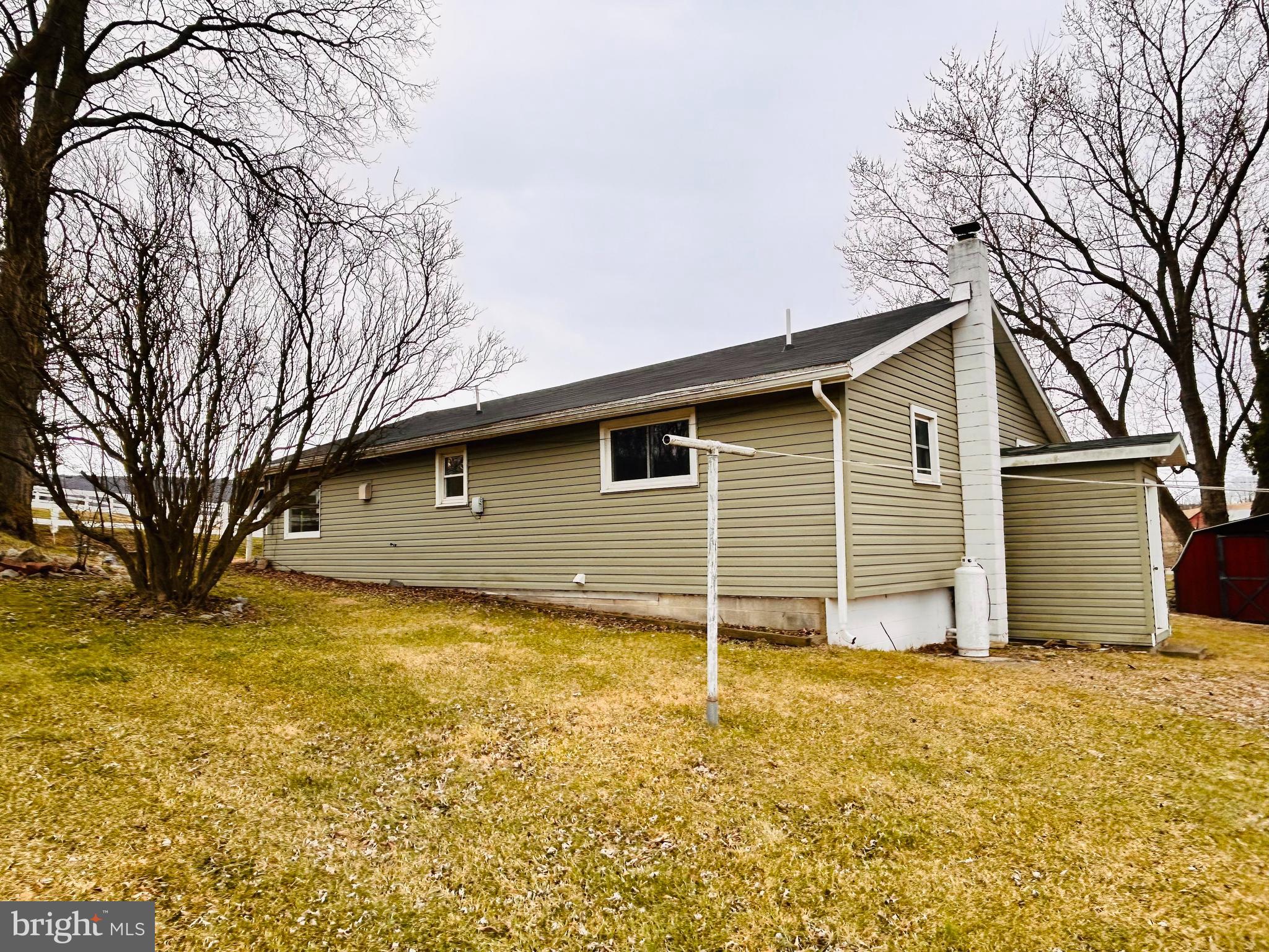 104 Apple Butter Road Aaronsburg, PA 16820 - Photo 13 of 33 a backyard of a house with wooden fence and large tree