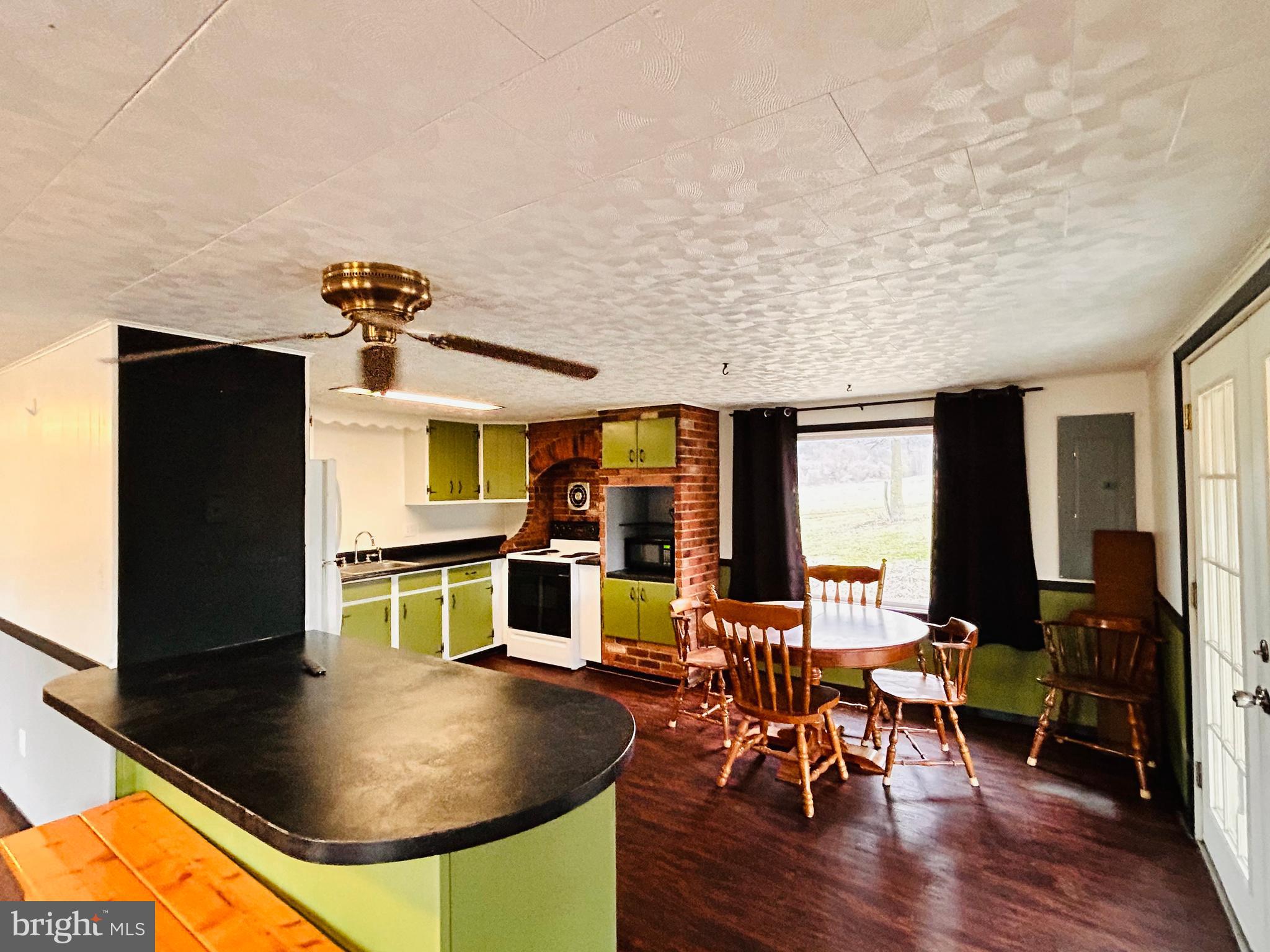 104 Apple Butter Road Aaronsburg, PA 16820 - Photo 32 of 33 a living room with dining table chairs and kitchen view