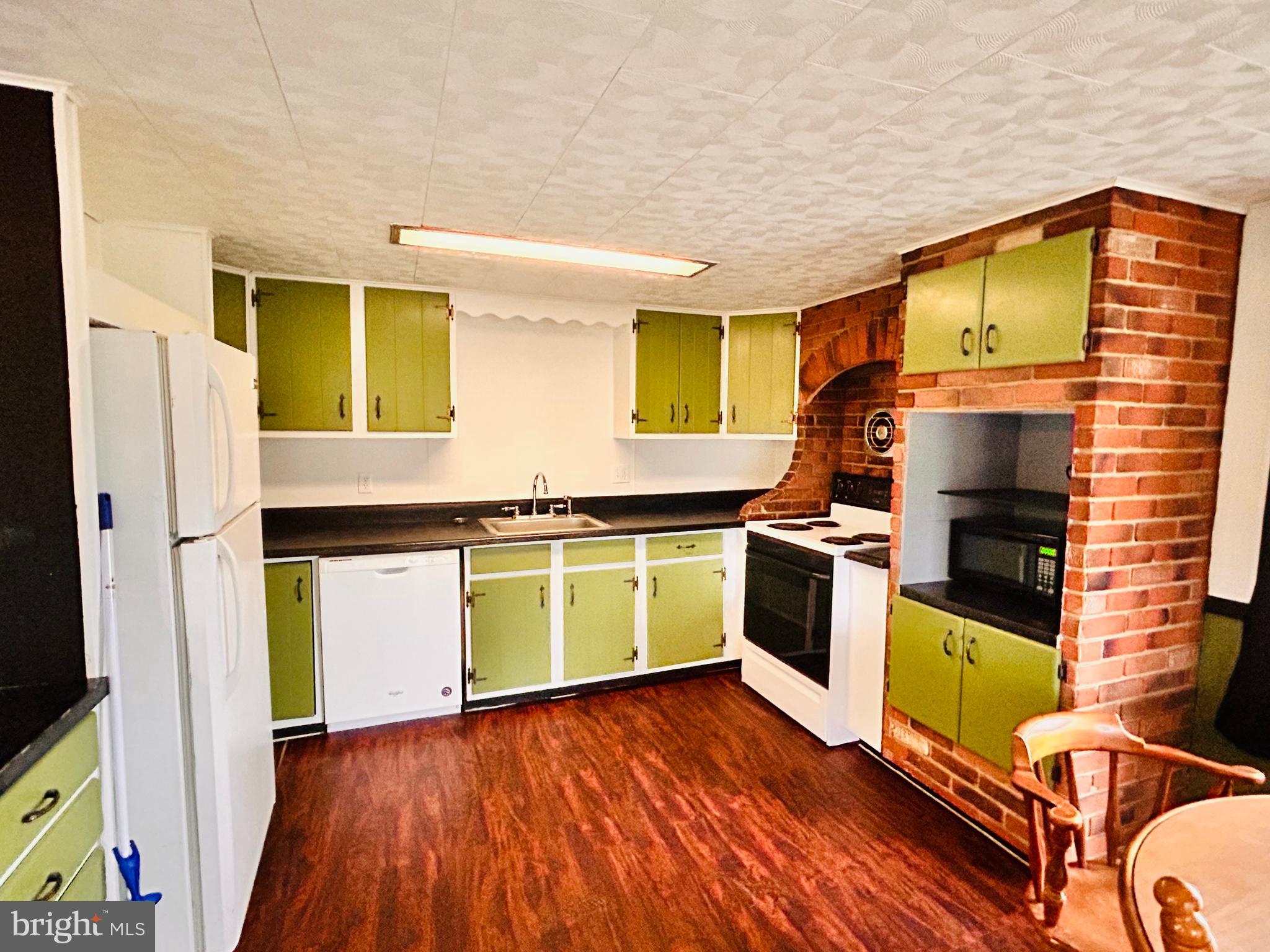 104 Apple Butter Road Aaronsburg, PA 16820 - Photo 33 of 33 a kitchen with wooden floors and a stove
