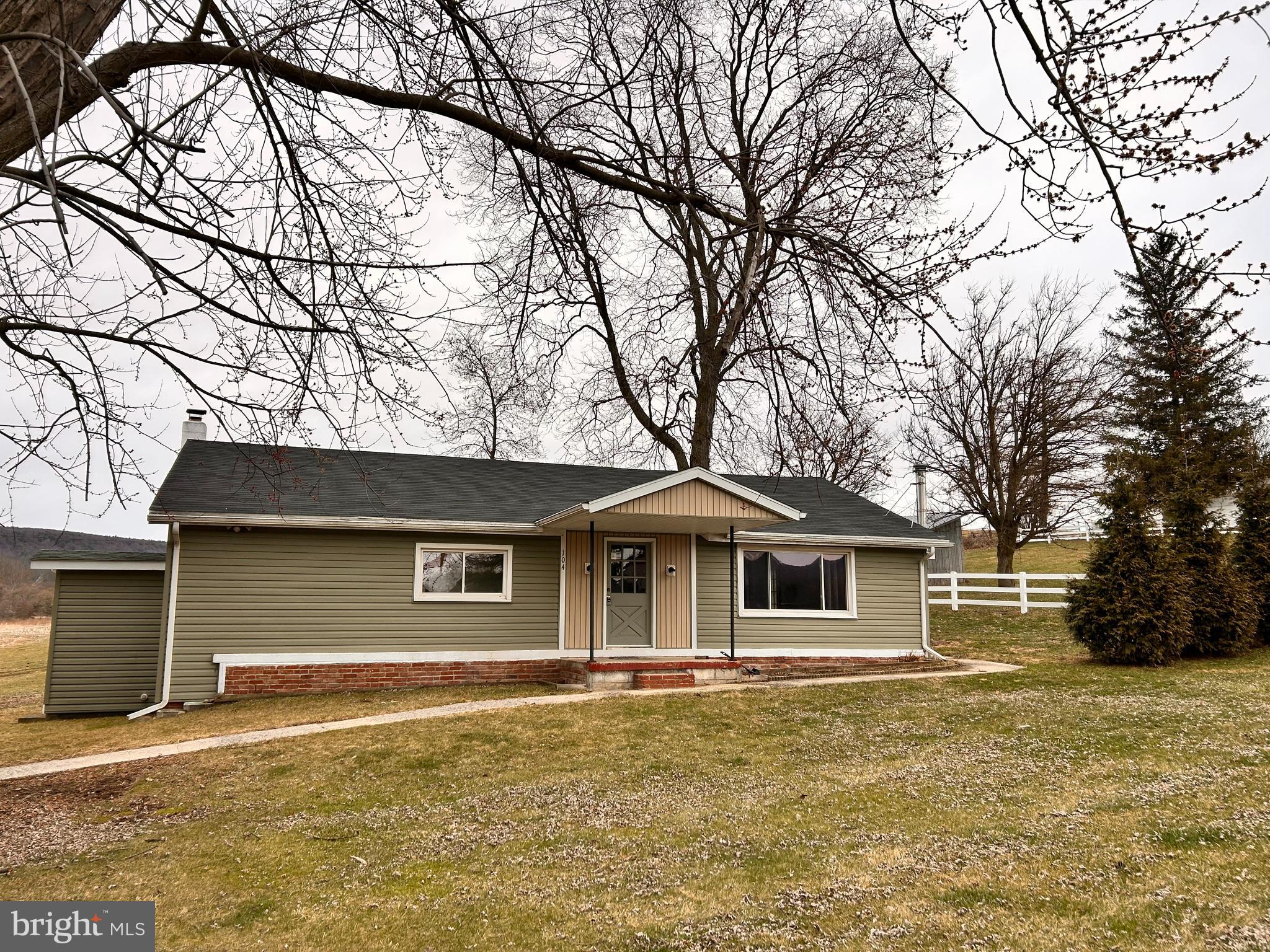 104 Apple Butter Road Aaronsburg, PA 16820 - Photo 7 of 33 a front view of a house with a garden