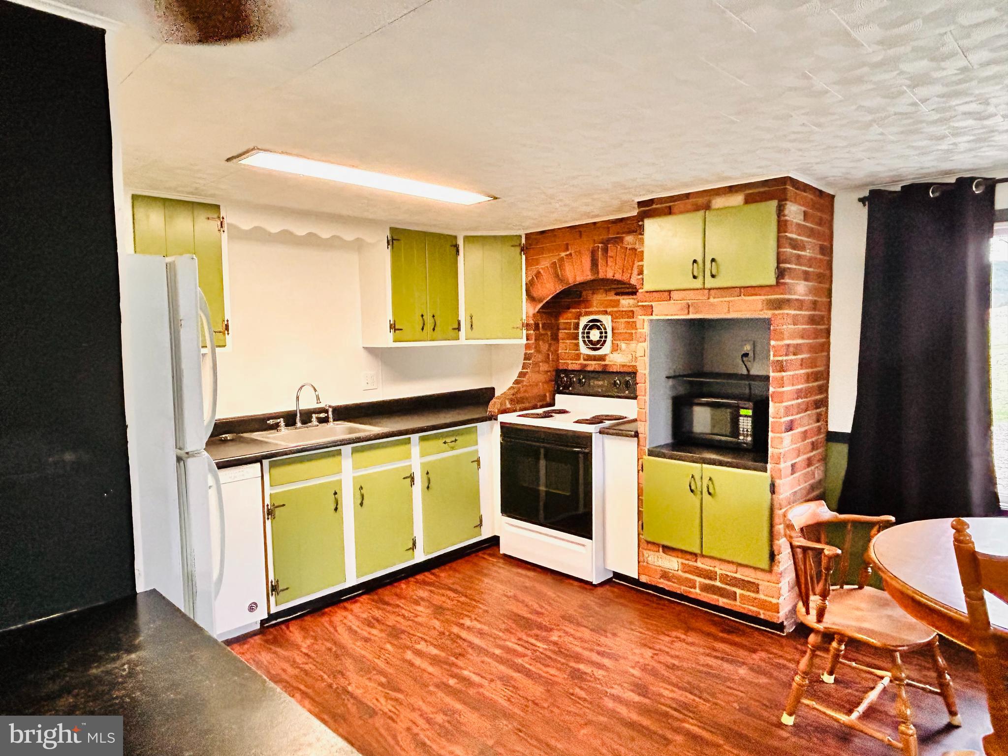 104 Apple Butter Road Aaronsburg, PA 16820 - Photo 8 of 33 a kitchen with a stove and a microwave