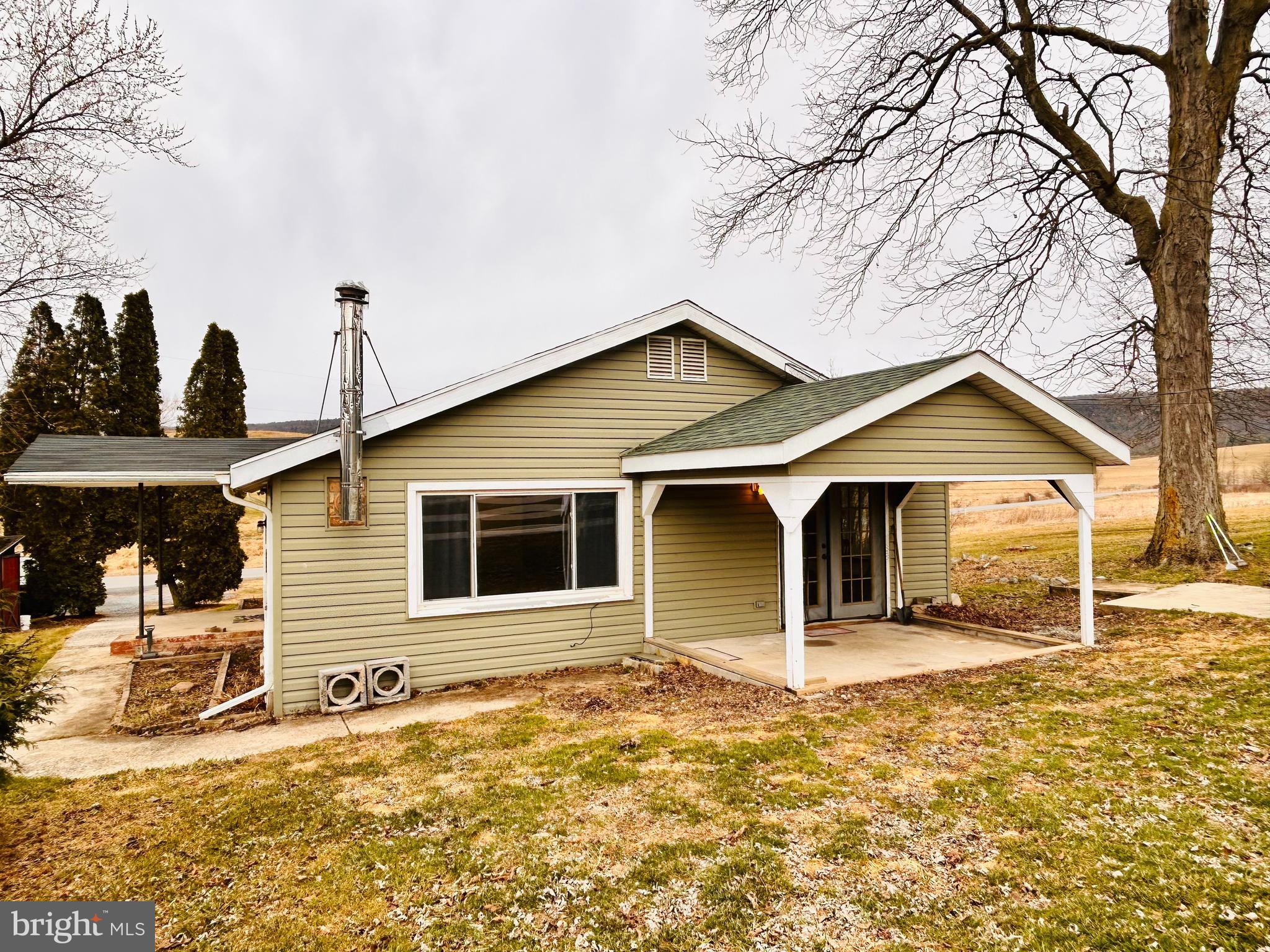 104 Apple Butter Road Aaronsburg, PA 16820 - Photo 10 of 33 a front view of a house with a yard and garage