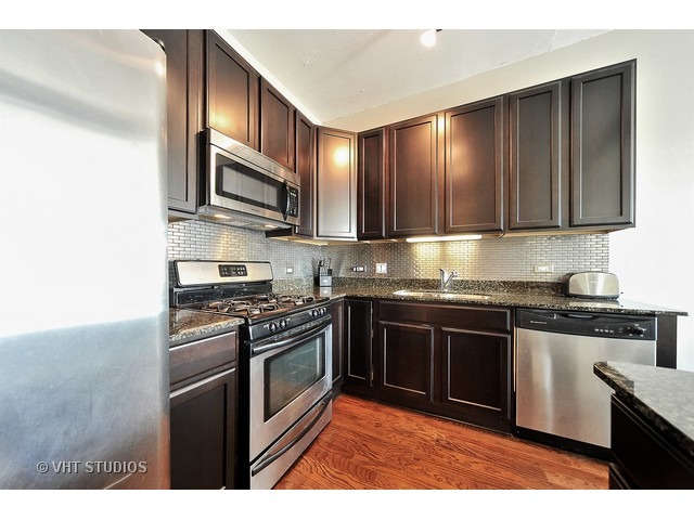909 West Washington Boulevard, Unit 901 Chicago, IL 60607 - Photo 5 of 10 a kitchen with stainless steel appliances granite countertop a stove top oven a sink and dishwasher