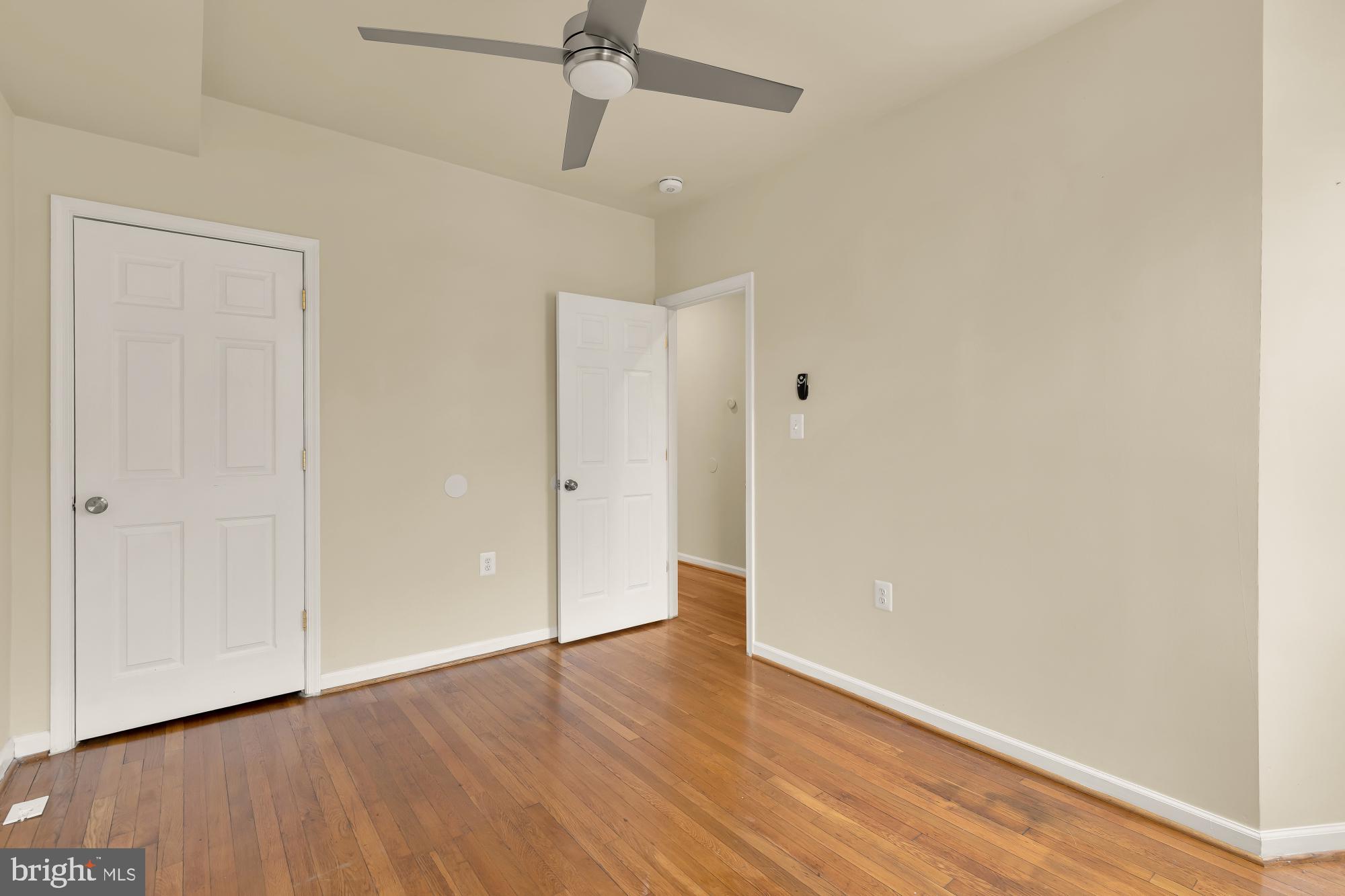 1721 West Virginia Avenue Northeast Washington, DC 20002 - Photo 11 of 20 an empty room with wooden floor a ceiling fan and closet area