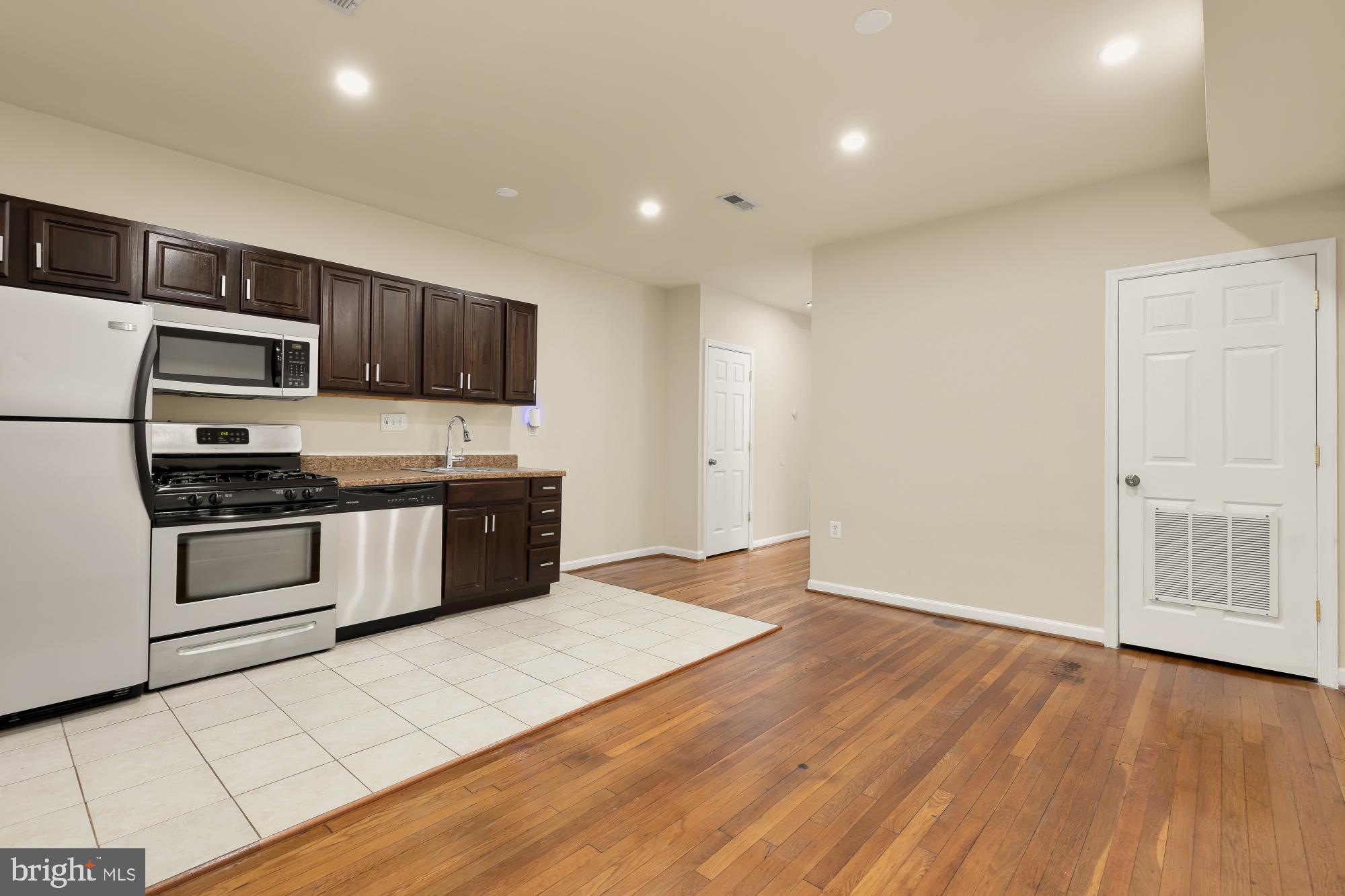 1721 West Virginia Avenue Northeast Washington, DC 20002 - Photo 2 of 20 a kitchen with stainless steel appliances a refrigerator and a stove top oven