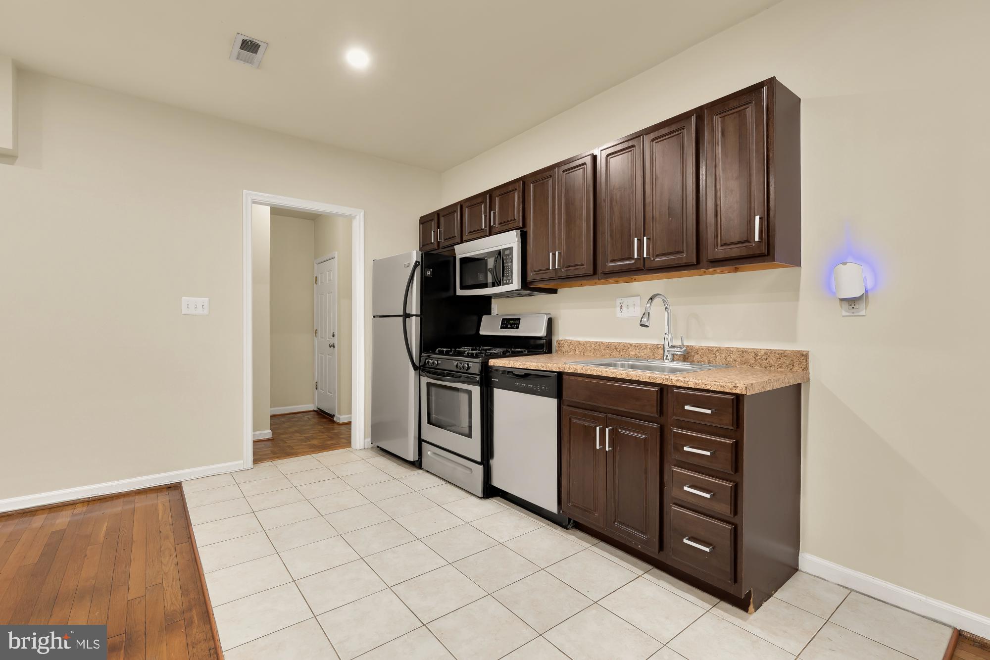 1721 West Virginia Avenue Northeast Washington, DC 20002 - Photo 7 of 20 a kitchen with stainless steel appliances granite countertop a refrigerator and a stove top oven
