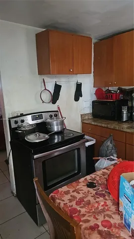 a stove top oven sitting inside of a kitchen