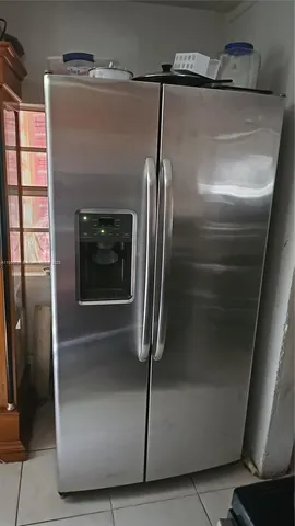 a refrigerator freezer sitting inside of a kitchen