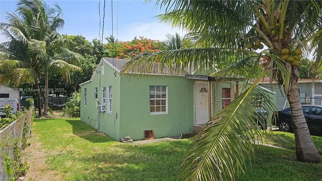 a yellow house with trees in front of it