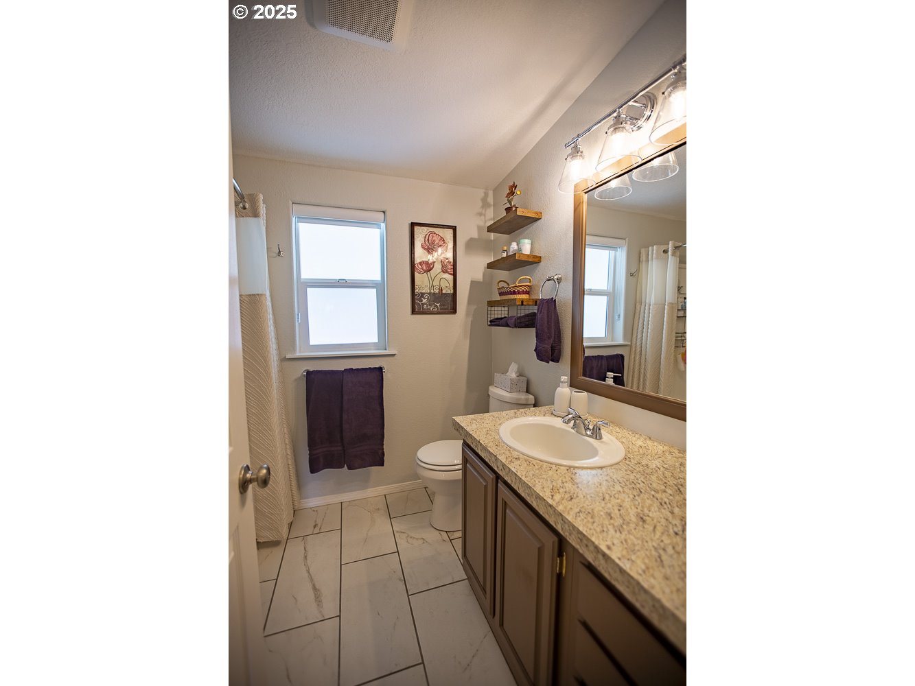 1208 Hill Street Cove, OR 97824 - Photo 12 of 33 a bathroom with a granite countertop sink and a mirror