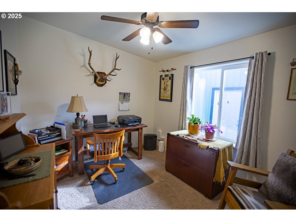 1208 Hill Street Cove, OR 97824 - Photo 14 of 33 a living room with furniture a chandelier and a window