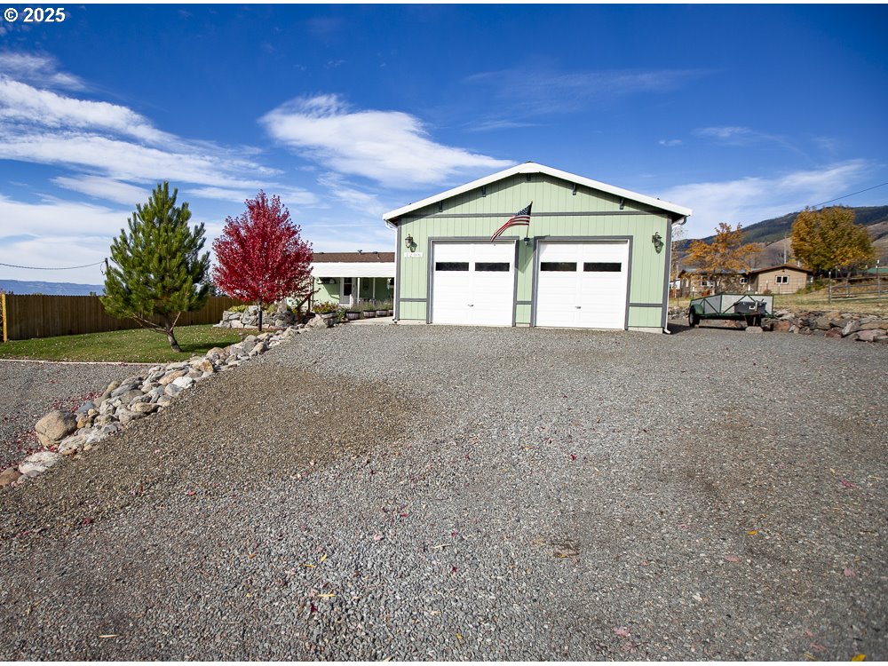 1208 Hill Street Cove, OR 97824 - Photo 19 of 33 a front view of a house with a yard and garage