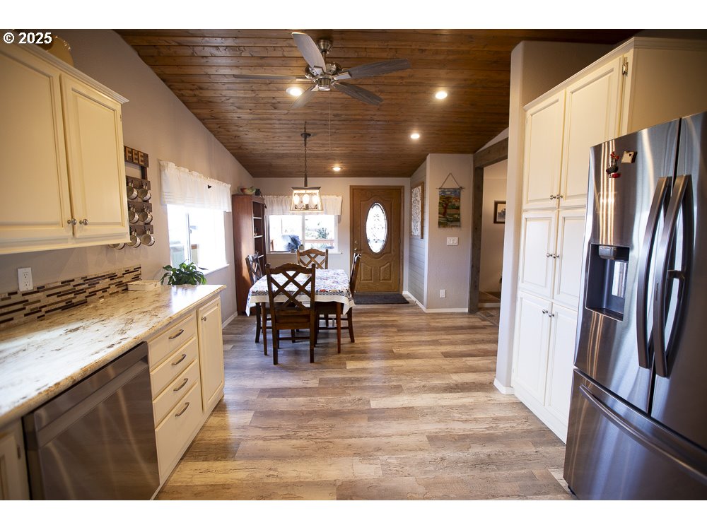 1208 Hill Street Cove, OR 97824 - Photo 2 of 33 a kitchen with stainless steel appliances granite countertop a refrigerator a stove and a sink