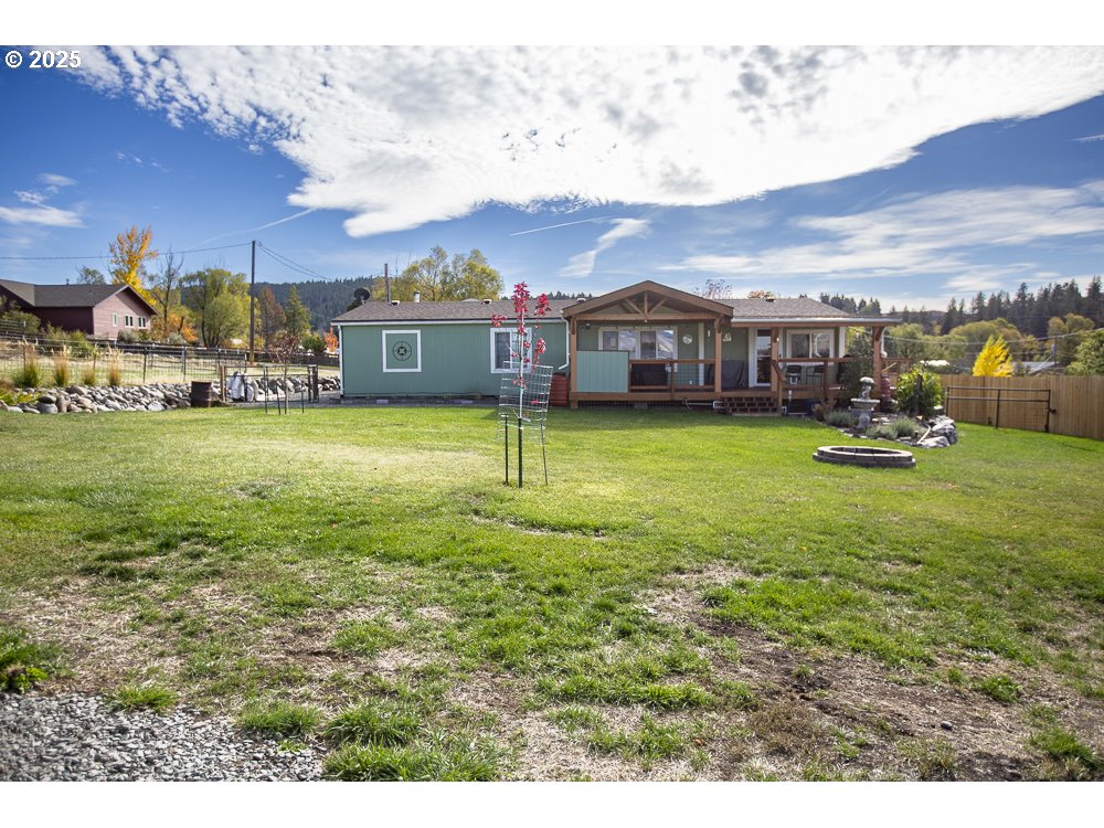 1208 Hill Street Cove, OR 97824 - Photo 24 of 33 a view of a houses with yard and mountain view in front of house