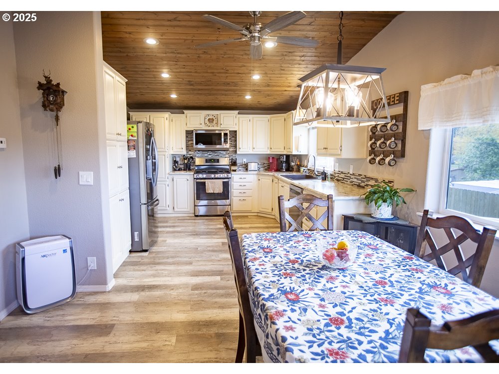 1208 Hill Street Cove, OR 97824 - Photo 4 of 33 a view of a dining room with furniture a chandelier and kitchen view