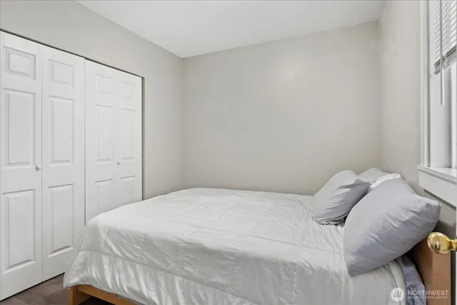 a bedroom with a bed and a window