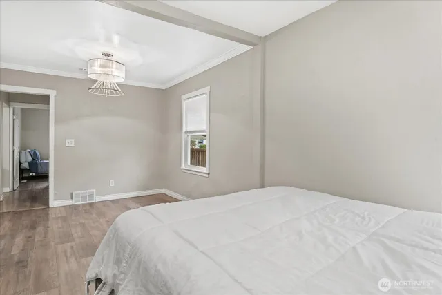 a bedroom with a bed and a chandelier