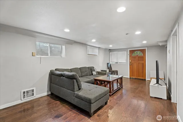 a living room with furniture and a wooden floor