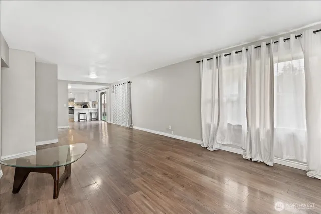 a view of a livingroom with furniture wooden floor and a table