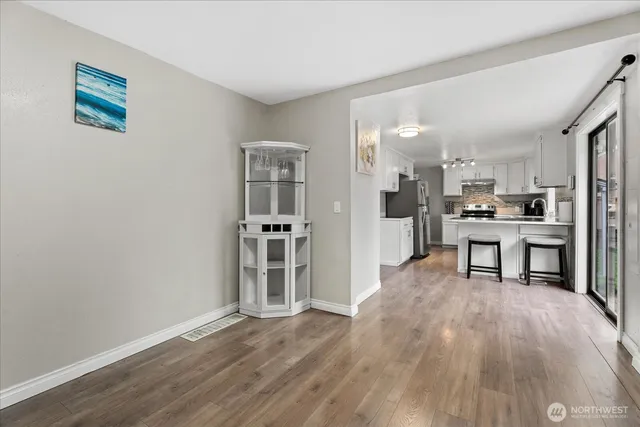a view of a kitchen with wooden floor and a kitchen