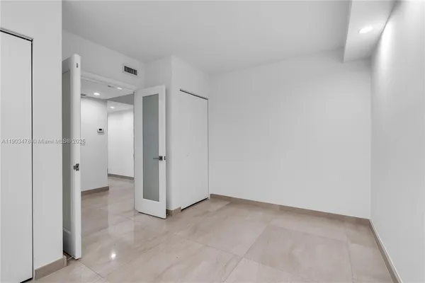 a bathroom with a granite countertop sink a toilet a mirror and shower