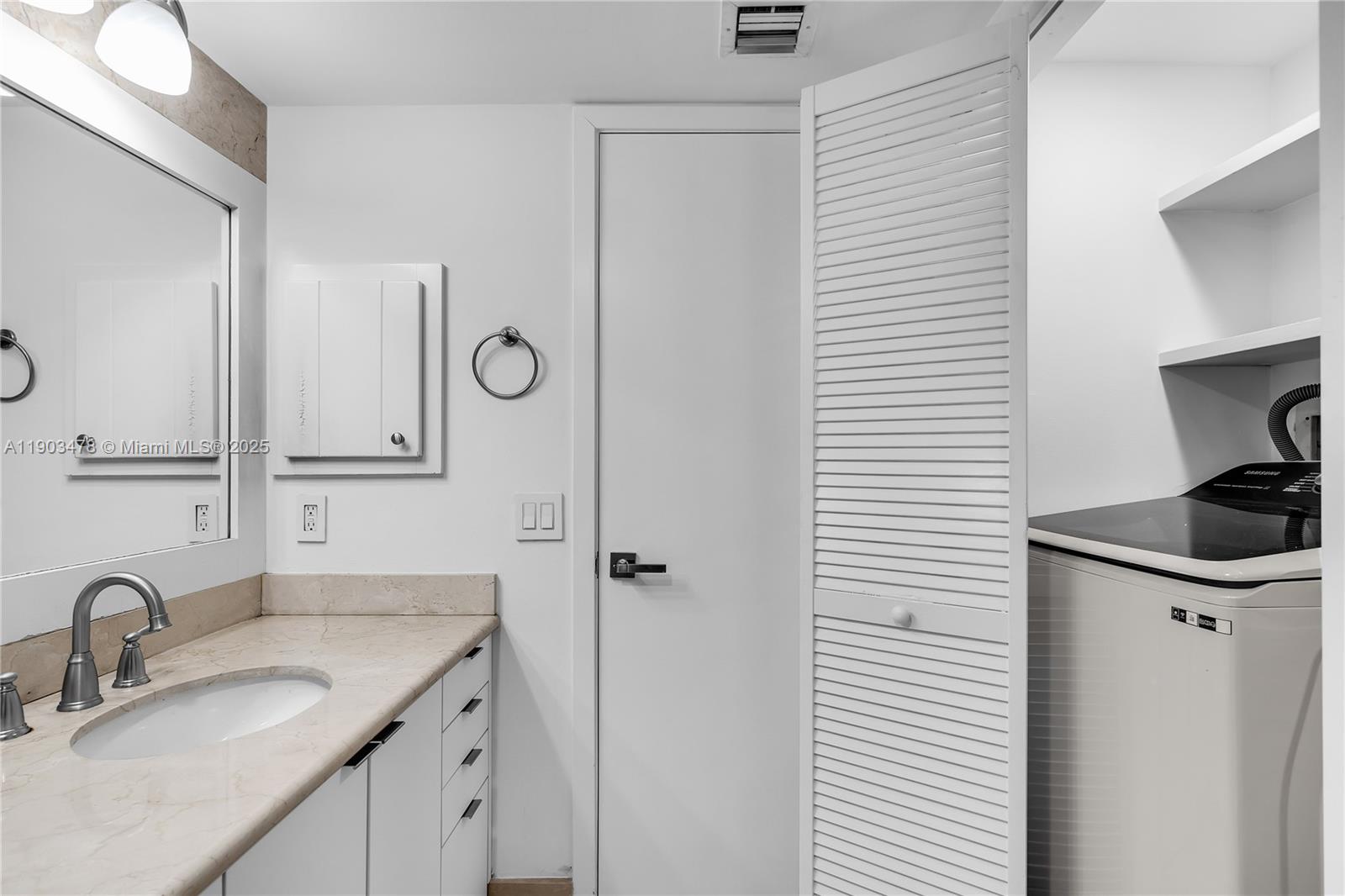 141 Crandon Boulevard, Unit 242 Key Biscayne, FL 33149 - Photo 15 of 42 a bathroom with a granite countertop sink and a mirror