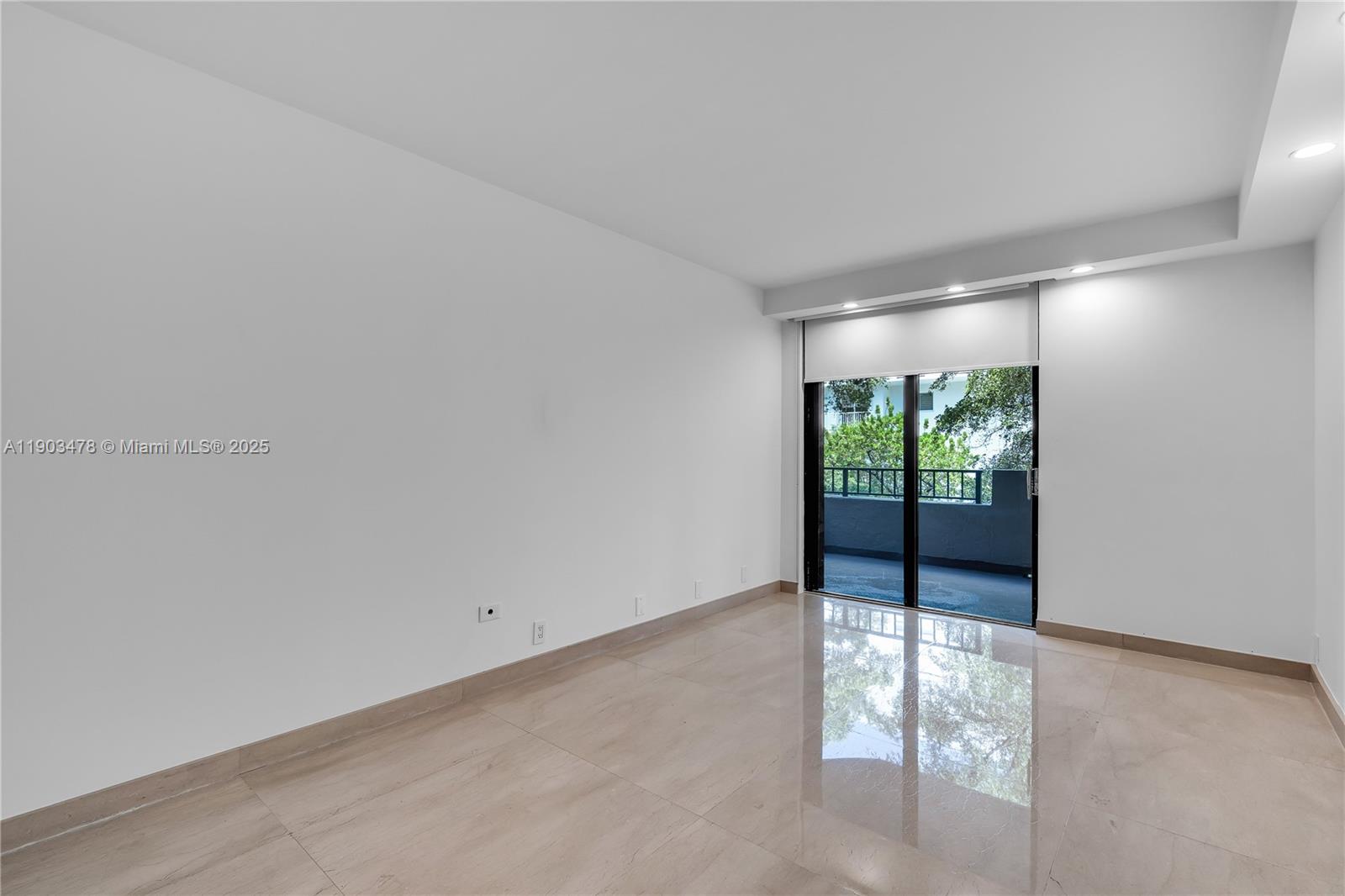 141 Crandon Boulevard, Unit 242 Key Biscayne, FL 33149 - Photo 17 of 42 an empty room with wooden floor and windows