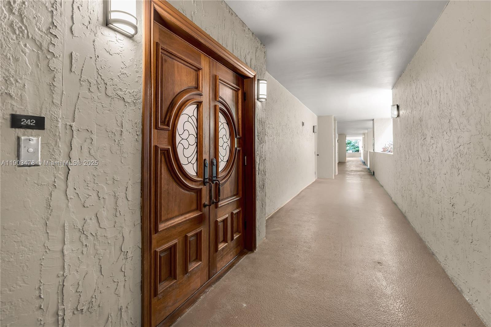 141 Crandon Boulevard, Unit 242 Key Biscayne, FL 33149 - Photo 2 of 42 a view of a hallway with wooden walls