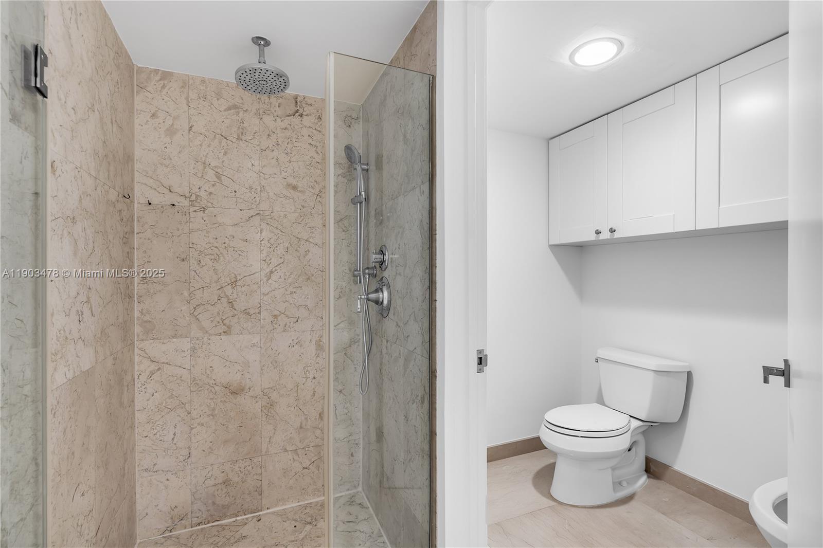 141 Crandon Boulevard, Unit 242 Key Biscayne, FL 33149 - Photo 28 of 42 a bathroom with a toilet and a shower