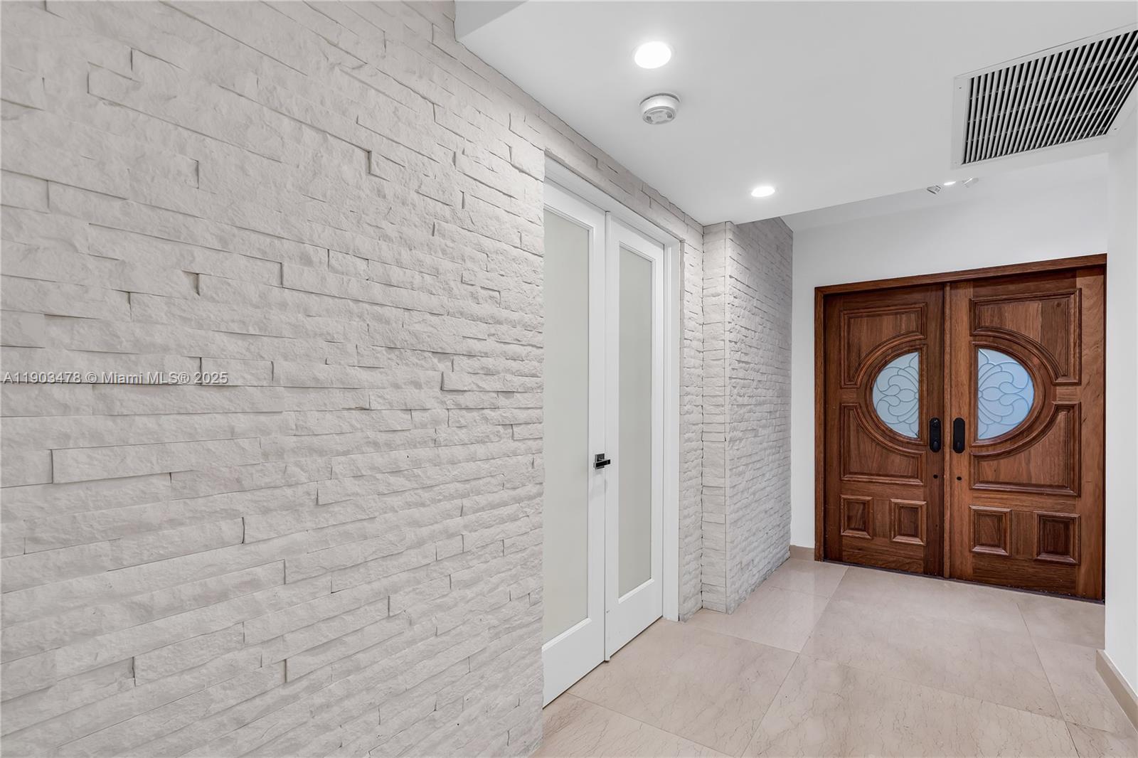 141 Crandon Boulevard, Unit 242 Key Biscayne, FL 33149 - Photo 4 of 42 a bathroom with a sink a mirror and a shower