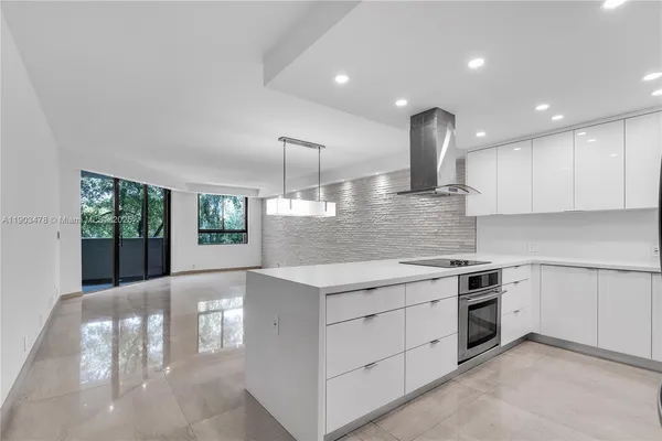 a kitchen with a stove and white cabinets