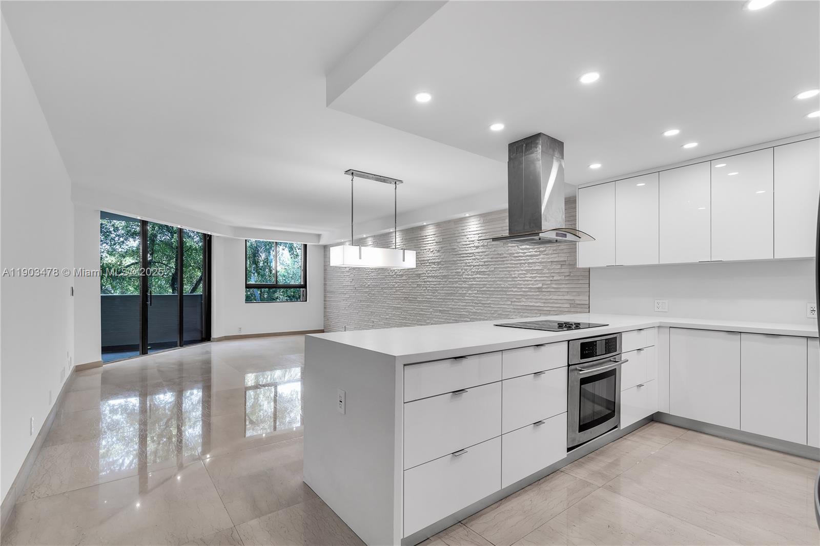 141 Crandon Boulevard, Unit 242 Key Biscayne, FL 33149 - Photo 5 of 42 a kitchen with a stove and white cabinets