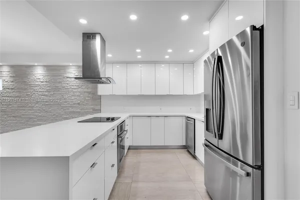 a kitchen with a sink stainless steel appliances and refrigerator